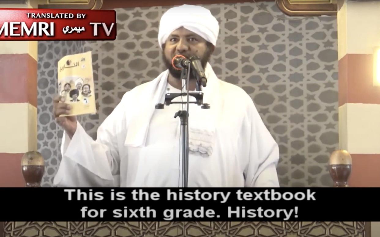 Sheikh Muhammed Al-Amin Ismail holding the history book during a sermon at a major mosque in Khartoum - YouTube screen grab