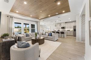 The Toll Brothers model home at Preserve at Beacon Lake features a great room, casual dining area, and covered lanai, all accessible from the kitchen.