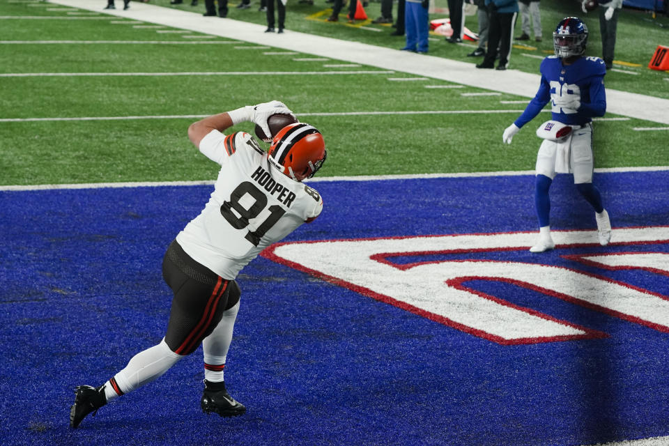 Cleveland Browns tight end Austin Hooper (81) catches a pass for a touchdown in front of New York Giants safety Xavier McKinney (29) during the first half of an NFL football game, Sunday, Dec. 20, 2020, in East Rutherford, N.J. (AP Photo/Seth Wenig)