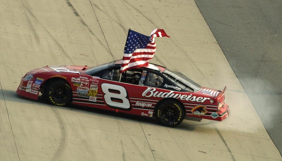 Dale Earnhardt Jr. spins out as he holds the American flag after he won the Cal Ripken Jr. 400 at Dover Downs International Speedway in Dover, Del., Sunday, Sept. 23, 2001.