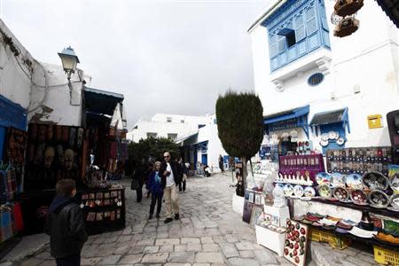 Tourists walk past traditional souvenirs displayed for sale in Sidi Bou Said, an attractive tourist destination, in Tunis February 19, 2013. REUTERS/Anis Mili