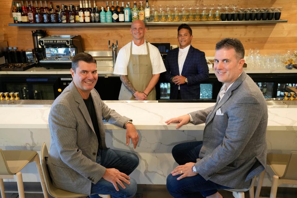 Owners Brett (left) and Christian Pezzuto (right) and Cory Oppold (back left) along with general manager Nicholas Padua inside their new restaurant Course, a new multicourse restaurant in Scottsdale.