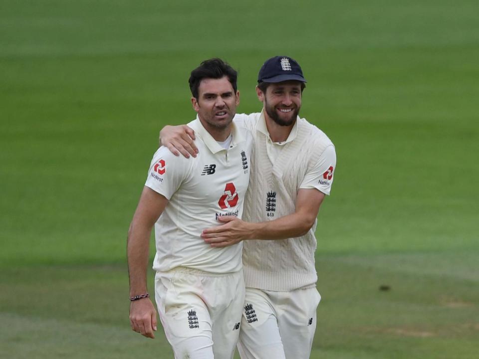 A snarling James Anderson is congratulated on his five-fer by Chris Woakes: Getty