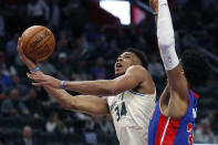 Milwaukee Bucks forward Giannis Antetokounmpo (34) makes a layup as Detroit Pistons forward Christian Wood (35) defends during the first half of an NBA basketball game, Thursday, Feb. 20, 2020, in Detroit. (AP Photo/Carlos Osorio)