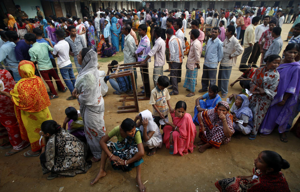 People wait in queue to cast their votes during the first phase of elections in Agartala, in the northeastern state of Tripura, India, Monday, April 7, 2014. India started the world's largest election Monday, with voters in the remote northeast making their way past lush rice paddies and over rickety bamboo bridges to reach the polls. The country's 814 million electorate will vote in stages over the next five weeks. (AP Photo/Saurabh Das)