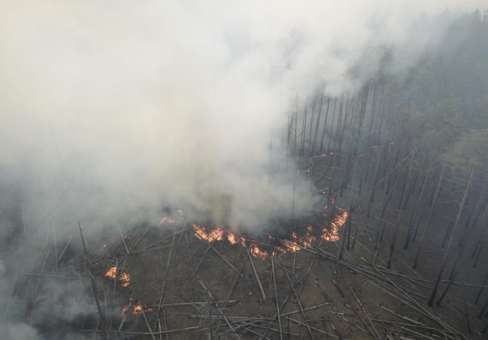 A view of a forest fire burning near the village of Volodymyrivka in the exclusion zone around the Chernobyl nuclear power plant, Ukraine, Sunday, April 5, 2020. (AP Photo/Yaroslav Yemelianenko)