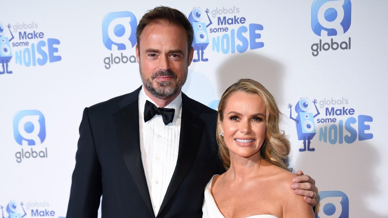 Jamie Theakston and Amanda Holden pose on red carpet