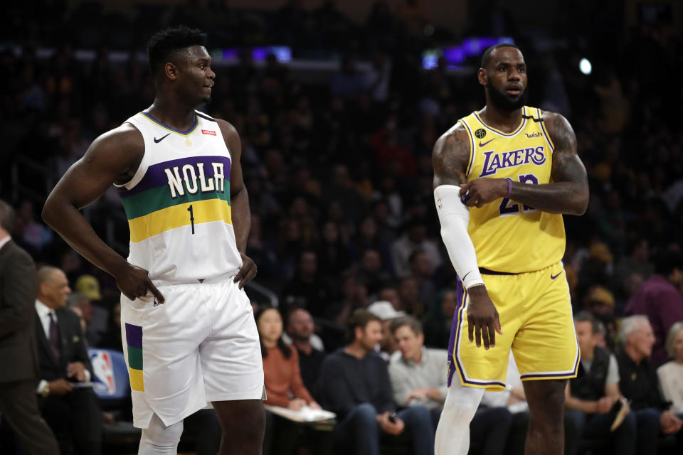 New Orleans Pelicans' Zion Williamson (1) stands next to Los Angeles Lakers' LeBron James during the first half of an NBA basketball game Tuesday, Feb. 25, 2020, in Los Angeles. (AP Photo/Marcio Jose Sanchez)