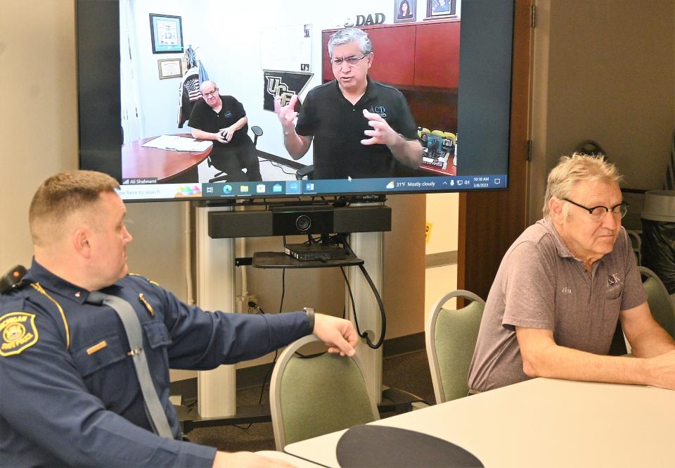 First Lt. Barry Schrader talks with ACD Telcom consultant Ali Shahnami on ZOOM while J&K engineer Jim Bowers listens at the 911 board meeting Wednesday.