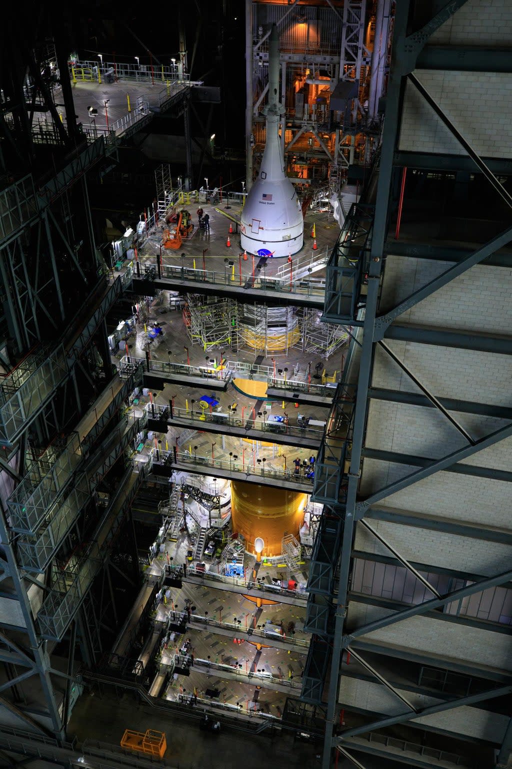 Ground teams work on Nasa’s Space Launch System Moon rocket and Orion spacecraft inside the Vehicle Assembly Building at Kennedy Space Center in Florida (Nasa)