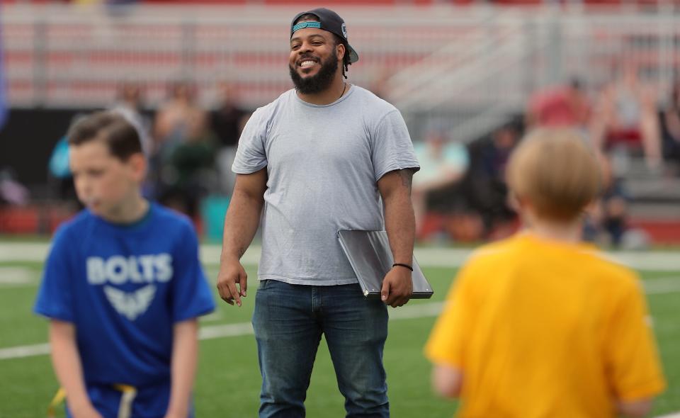 Bolts coach H'arion Gaulden grins as his team lines up for the snap against the Commanders at Central Kitsap's Cougar Field on Thursday, June 23, 2022.