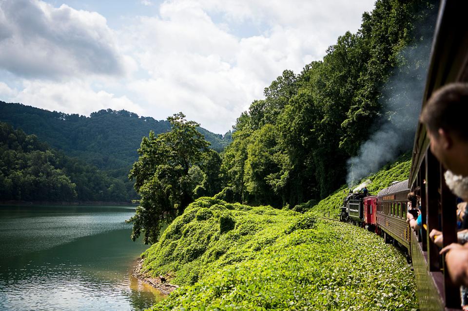 Steam engine no. 1702 snakes its way through the mountains beside Lake Fontana Friday July 29, 2016. The steam engine, built in 1942 and part of the Great Smoky Mountain Railroad, had its first run in 12 years on Tuesday July 26. It is one of three working steam engines of its kind it the country. 