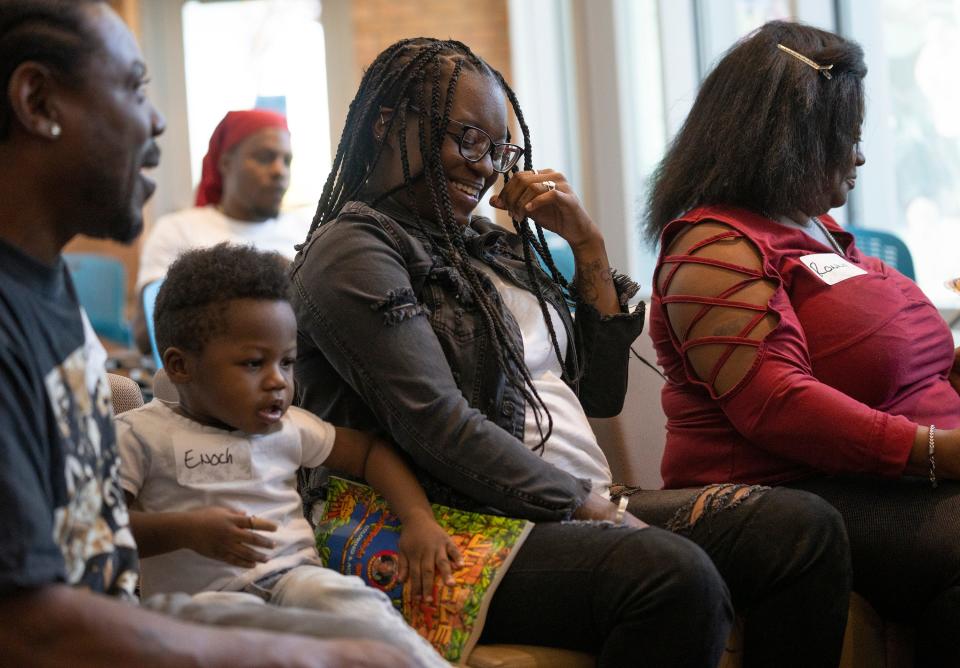 Kenyatta Williams, sister of DeVille Morrow, laughs during a meeting Sunday between relatives of Morrow and Jess Schnur at the Lifeline of Ohio offices. Schnur received a liver from Morrow, 29, a father of five who passed away on Aug. 9, 2021.