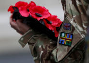 <p>An army cadet holds a poppy wreath during the Western Front Association service at the Cenotaph to remember servicemen and women killed conflict, in London, Britain, Nov. 11, 2017. (Photo: Peter Nicholls/Reuters) </p>