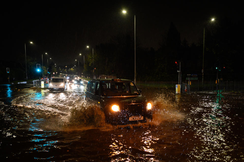 LONDON, ENGLAND - NOVEMBER 02: Vehicles negotiate a flooded section of the A1 road on November 02, 2022 in London, England. Torrential rain and flash flooding hit the region late on Wednesday evening, causing traffic jams as cars became stuck in the standing water. (Photo by Leon Neal/Getty Images)