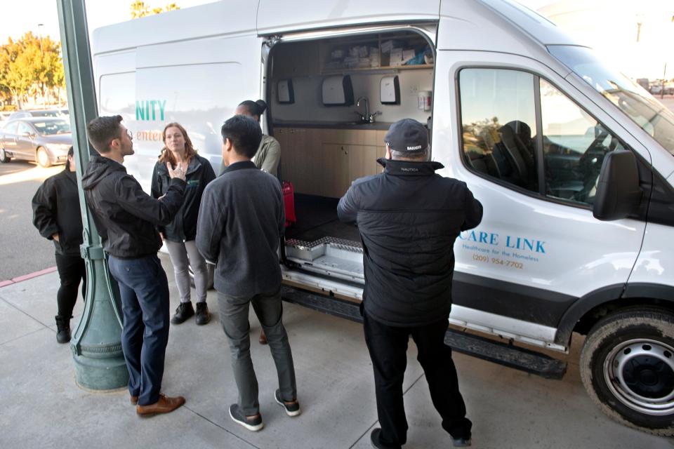 People check out a mobile van to be used in Stocktonâ€šÃ„Ã´s first-of-its-kind mobile crisis intervention response pilot program which was introduced at a news conference at the Stockton Ballpark in downtown Stockton on Thursday, Nov. 3, 2022. The program, a joint venture between CMC and the City of Stockton, will deal behavioral health calls that are currently handled by the police.  