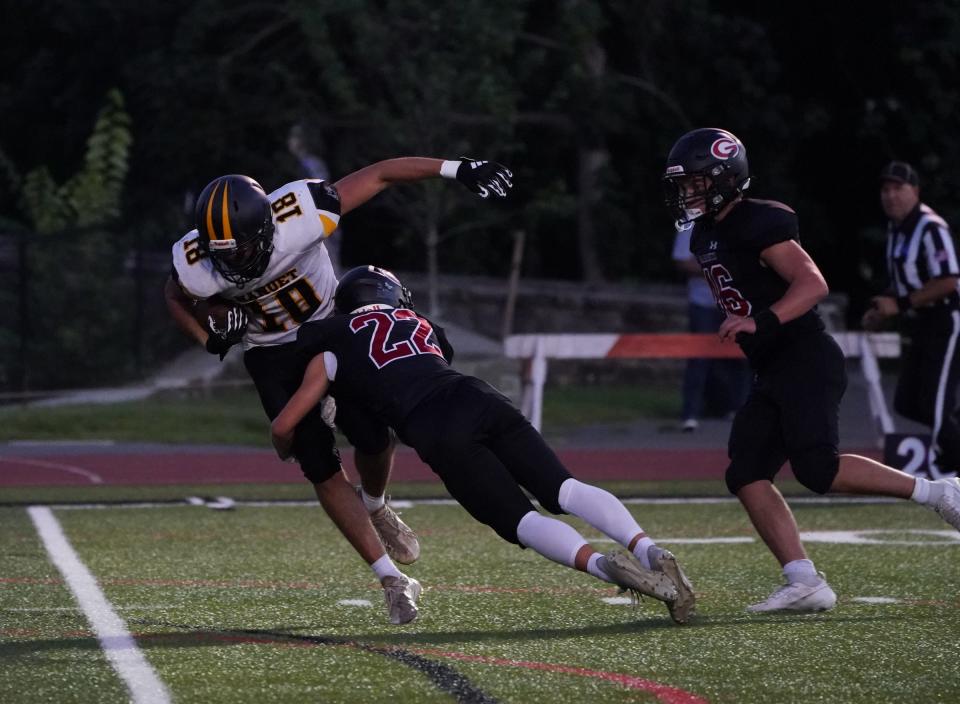 Nanuet's Jack O'Sullivan (18) is tackled by Rye's Archer Fenton (22) during football action at Rye High School on Thursday, September 14, 2023.