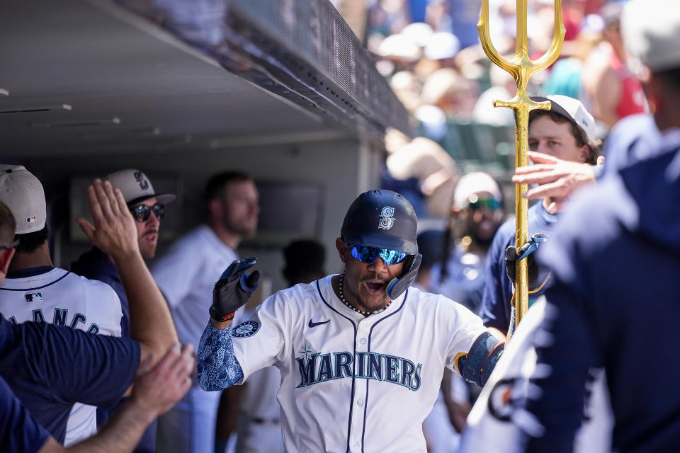 Seattle Mariners' Julio Rodríguez holds a trident in the dugout after his solo home run against the Baltimore Orioles during the fifth inning of a baseball game Thursday, July 4, 2024, in Seattle. (AP Photo/Lindsey Wasson)