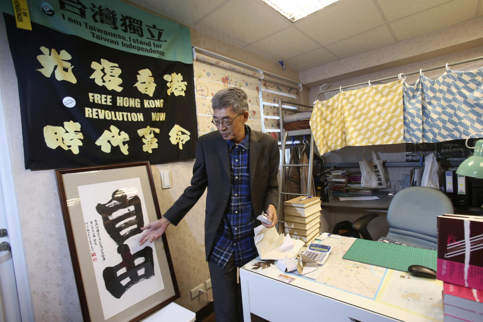 Lam Wing-kee, one of five shareholders and staff at the Causeway Bay Book shop in Hong Kong, shows his congratulatory gift, Chinese calligraphy that reads: ''Freedom'' at his new book shop on the opening day in Taipei, Taiwan, Saturday, April 25, 2020. The part-owner of the Hong Kong bookstore specializing in texts critical of China’s leaders reopened his shop in Taiwan on Saturday after fleeing Hong Kong due to legal troubles, saying he was grateful for the opportunity to make China's Communist rulers “less than happy." (AP Photo/Chiang Ying-ying)