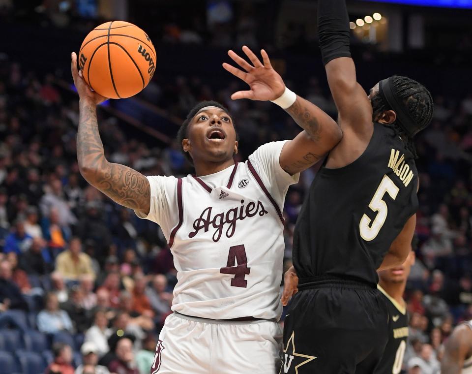 Texas A&M guard Wade Taylor IV (4) shoots over Vanderbilt guard Ezra Manjon (5) during the second half of their NCAA tournament game at Bridgestone Arena.