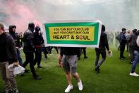 Manchester United fans protest against their owners before the Manchester United v Liverpool Premier League match