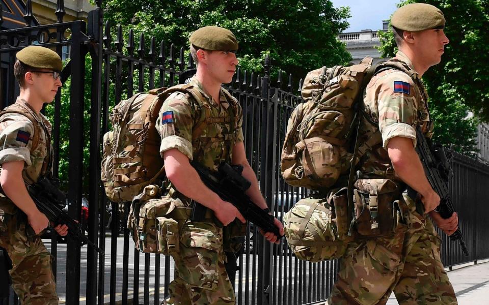 British soldiers enter a Ministry of Defence building - Credit: JUSTIN TALLIS/AFP