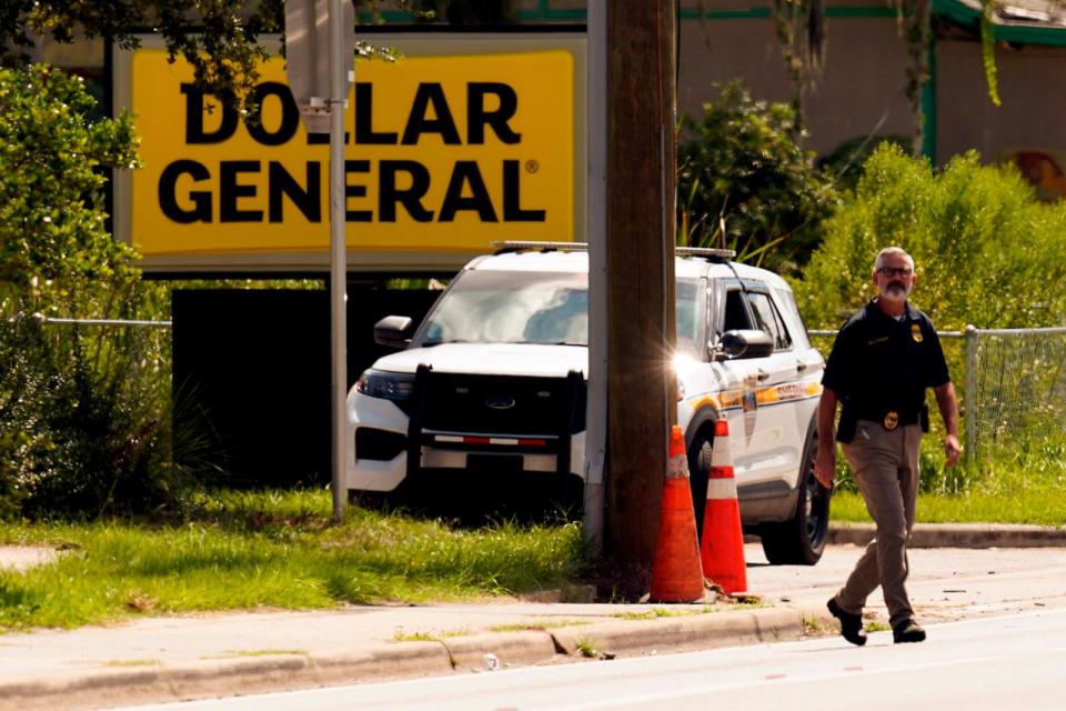 PHOTO: Law enforcement officials continue their investigation at a Dollar General Store that was the scene of a mass shooting, Aug. 27, 2023, in Jacksonville, Fla.  (John Raoux/AP)