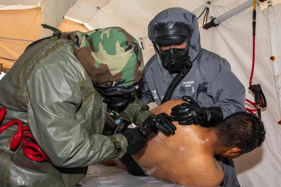 U.S. Soldiers assigned to the 526th Engineer Company, 92nd Engineer Battalion, 20th Engineer Brigade, from Fort Stewart, Ga., and Mexican army soldiers assigned to the 19th Motorized Cavalry Regiment decontaminate a simulated casualty after pulling them from an area with chemical, biological, radiological or nuclear contamination during exercise Fuerzas Amigas 2022 at Campo Militar Reynosa, Mexico, Oct. 19, 2022. (U.S. Navy photo by Mass Communication Specialist 1st Class Michael H. Lehman)