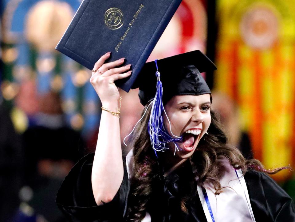 Alivia Hill celebrates as she heads back to her seat after crossing the stage during MTSU’s afternoon 2024 Spring Commencement ceremony at Murphy Center, on Saturday, May 4, 2024.