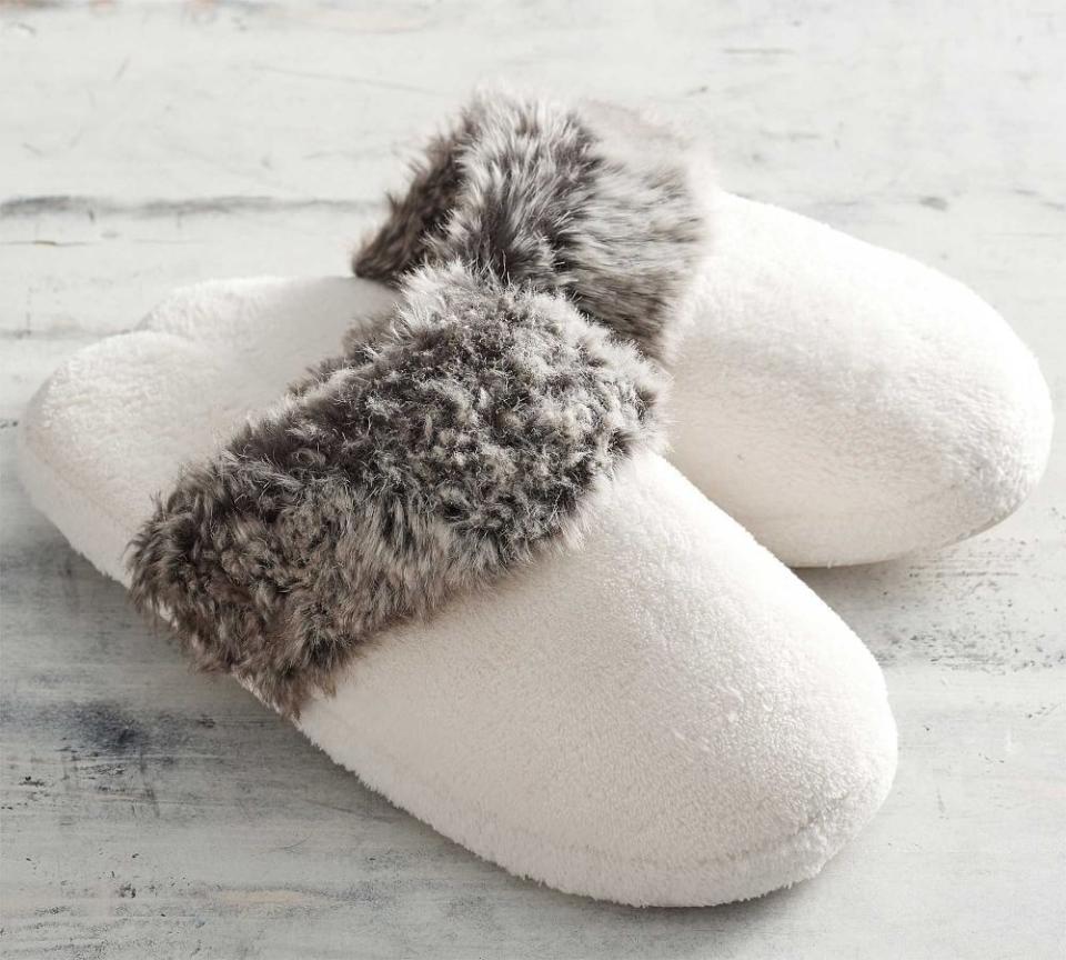 <p><strong>Pottery Barn</strong></p><p>potterybarn.com</p><p><strong>$39.50</strong></p><p>These plush ivory slippers feature a faux-fur lining, making them simultaneously cozy and chic. Congrats: You don't have to sacrifice style while you're working from home or taking a self-care day.</p>