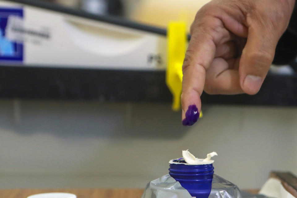 An Iraqi dips his finger to show that he voted in the country's provincial elections in Basra, Iraq, Monday, Dec. 18, 2023. (AP Photo/Nabil al-Jurani)