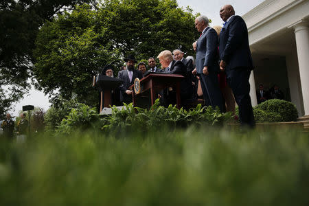 U.S. President Donald Trump signs an Executive Order on Promoting Free Speech and Religious Liberty during the National Day of Prayer event at the Rose Garden of the White House in Washington D.C., U.S., May 4, 2017. REUTERS/Carlos Barria