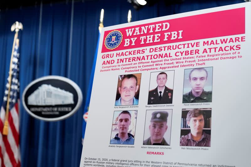 A poster showing six wanted Russian military intelligent officers is displayed before a news conference at the Department of Justice, in Washington