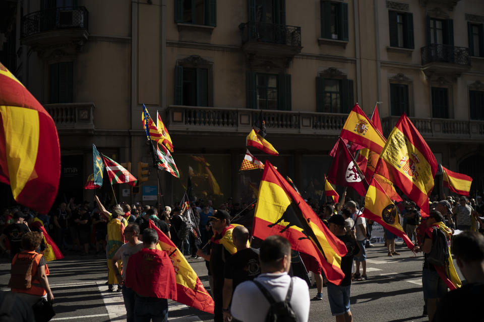 Members and supporters of National Police and Guardia Civil wave Spanish flags during a protest demanding better pay in Barcelona, Spain, Saturday, Sept. 29, 2018. (AP Photo/Felipe Dana)