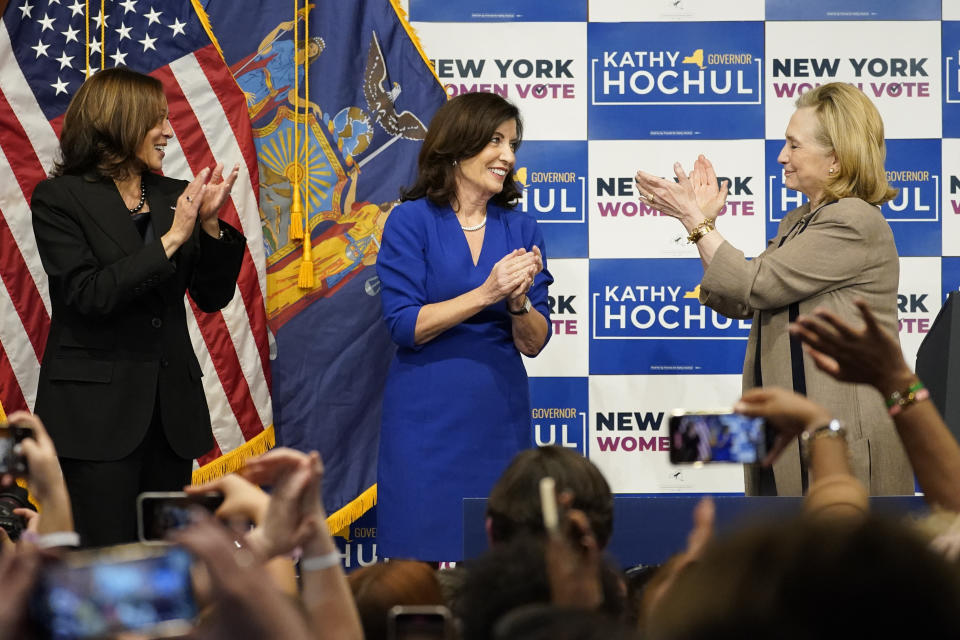 Vice President Kamala Harris, left, New York Gov. Kathy Hochul, center and former Secretary of State Hillary Clinton, stand together on stage during a campaign event for Hochul, Thursday, Nov. 3, 2022, at Barnard College in New York. (AP Photo/Mary Altaffer)