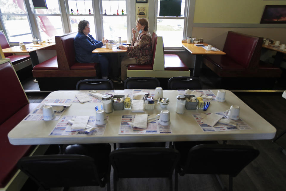 FILE - In this May 18, 2020 file photo, customers dine inside at the Hot Spot Diner in Wiscasset, Maine. Governor Janet Mills is now allowing restaurants in 12 of the state's 16 counties to have dine-in customers. As of this week, 32 states have allowed dining rooms to open at least partially. And restaurant executives say customers are curious and eager to eat out.(AP Photo/Robert F. Bukaty, File)