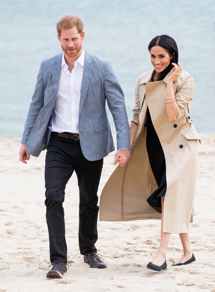 Meghan Markle and Prince Harry chose to keep their shoes on during a visit to South Melbourne beach yesterday. Source: Getty