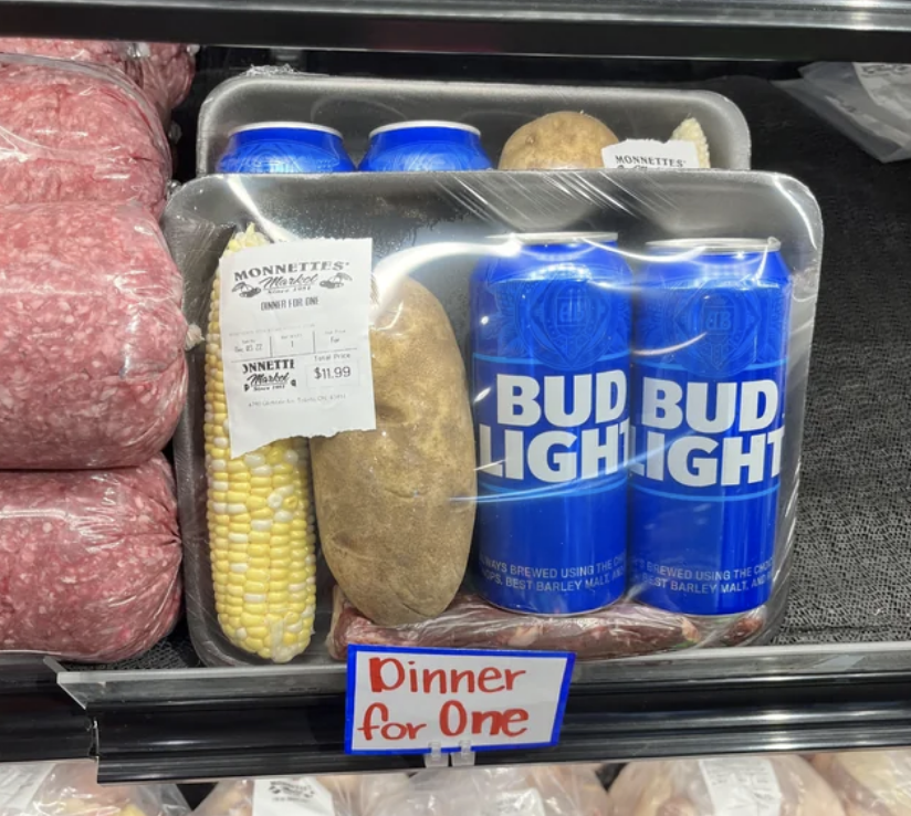 "Dinner for one" with a corn on the cob, a potato, and two Bud Lights