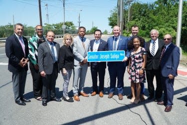 From left, Union County Prosecutor William Daniels, Linden 3rd Ward Councilwoman Monique Caldwell, Linden 2nd Ward Councilman Barry Javick, Linden Council President Michele Yamakaitis, Linden Mayor Derek Armstead, Senate President Nicholas Scutari, Union County Commissioner Christopher Hudak, Linden 6th Ward Councilman John Francis Roman, Linden 1st Ward Councilwoman Lisa Ormon, Linden City Clerk Joseph Bodek and Linden 7th Ward Councilman Ralph Strano, participate in the ceremony naming Senator Joseph Suliga Way in the city's Tremley Point section.