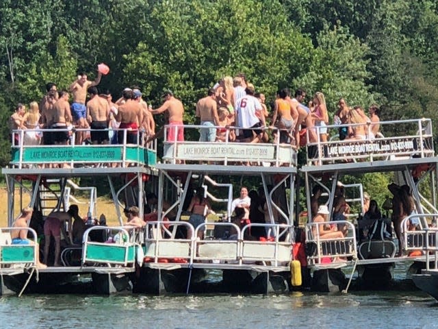 Indiana University students gather on boats on Lake Monroe.