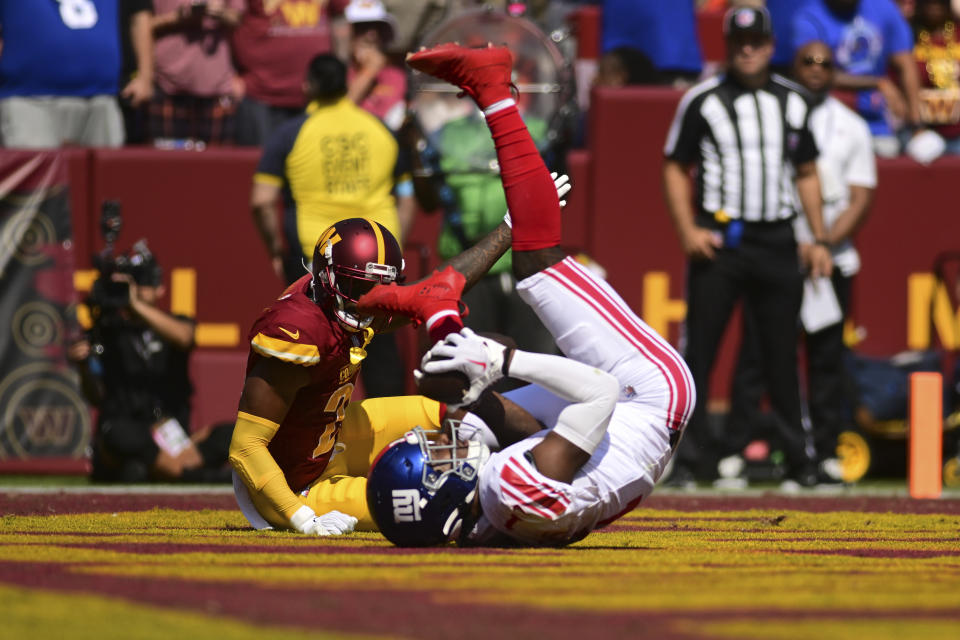 New York Giants wide receiver Malik Nabers, front, catches a touchdown pass against the Washington Commanders during the first half of an NFL football game in Landover, Md., Sunday, Sept. 15, 2024. (AP Photo/Steve Ruark)