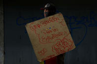 <p>A demonstrator holding a rudimentary shield that reads “A benediction for the students”, poses for a picture before a rally against Venezuelan President Nicolas Maduro’s government in Caracas, Venezuela, May 24, 2017. He said: “I am in the streets resisting because in this country we are living in a dictatorship and we want to have a better future for our children. Because food is not available, there are no jobs, no production of anything, we have high cost of living and insecurity.” (Photo: Carlos Garcia Rawlins/Reuters) </p>