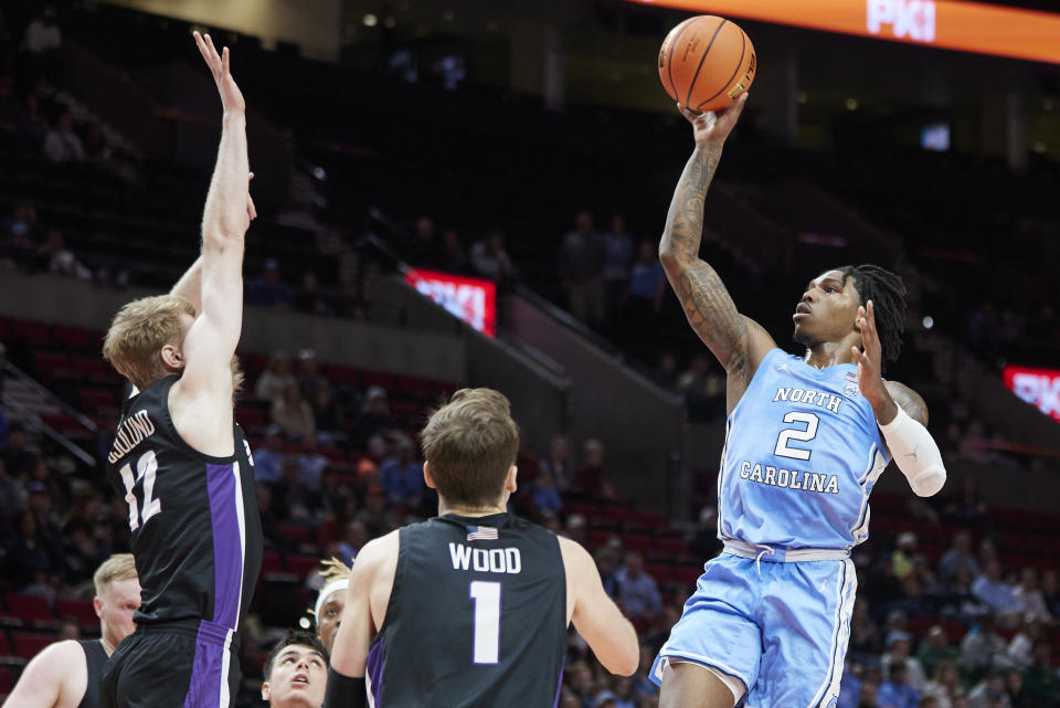 North Carolina guard Caleb Love, right, shoots over Portland forward Kristian Sjolund, left, and forward Moses Wood during the first half of an NCAA college basketball game in the Phil Knight Invitational tournament in Portland, Ore., Thursday, Nov. 24, 2022. (AP Photo/Craig Mitchelldyer)