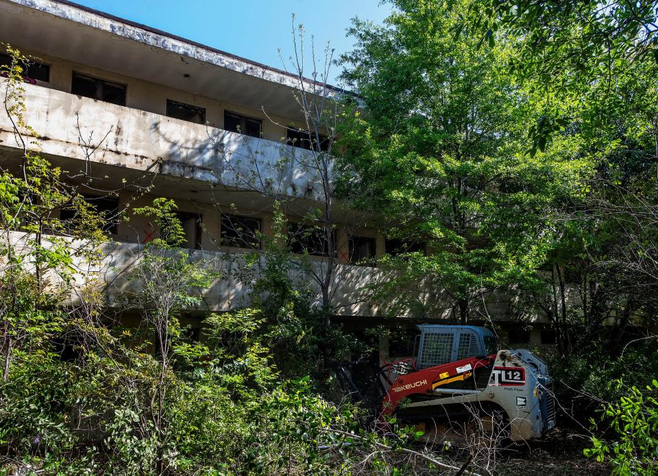 Brush clearing and site cleanup at the historic Grove Court Apartments are shown on April 6, 2021. Jud Blount and his uncle and business partner, Tom Blount, are renovating and rehabbing the 1940s structure that’s on the National Register of Historic Places.