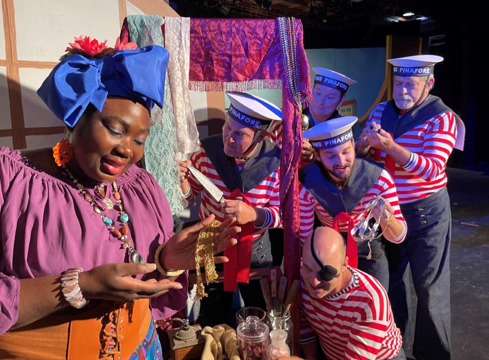 "Buttercup," played by Bibiana Dolcin, entices the ship's crew to buy her merchandise in the Gilbert and Sullivan operetta "H.M.S. Pinafore," on stage at Surfside Playhouse through Nov. 20, 2022. Visit surfsideplayhouse.com.