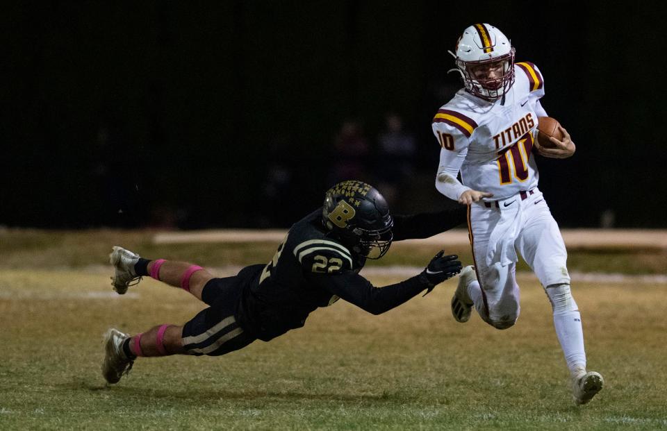 Gibson Southern’s Tanner Boyd (10) eludes the tackle of Boonville’s Reece Wilder (22) during their game at Bennett Field in Boonville, Ind., Friday evening, Oct. 14, 2022.