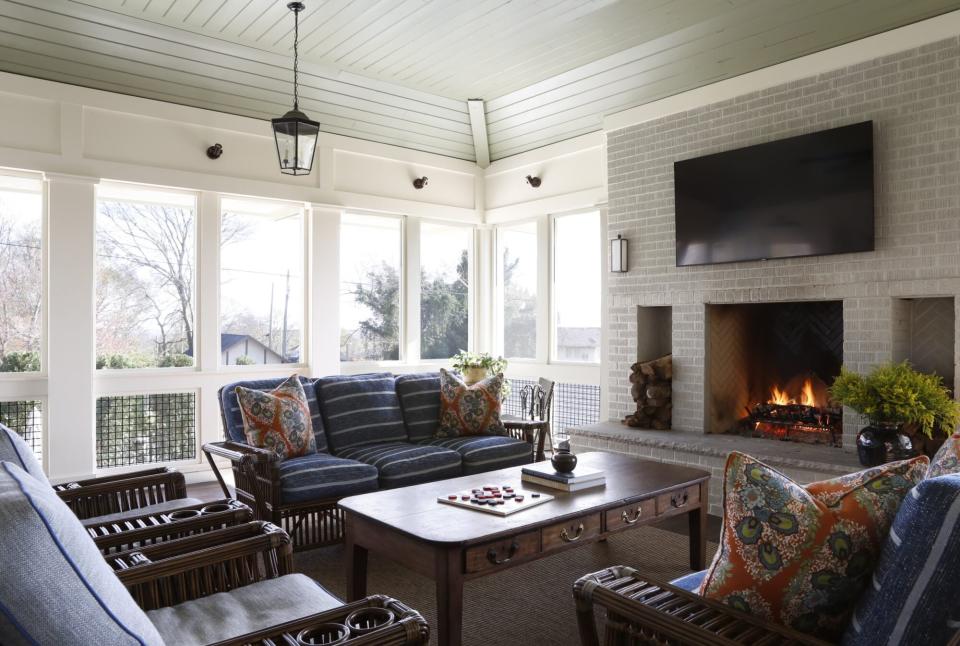 sunroom with a fireplace and a tv