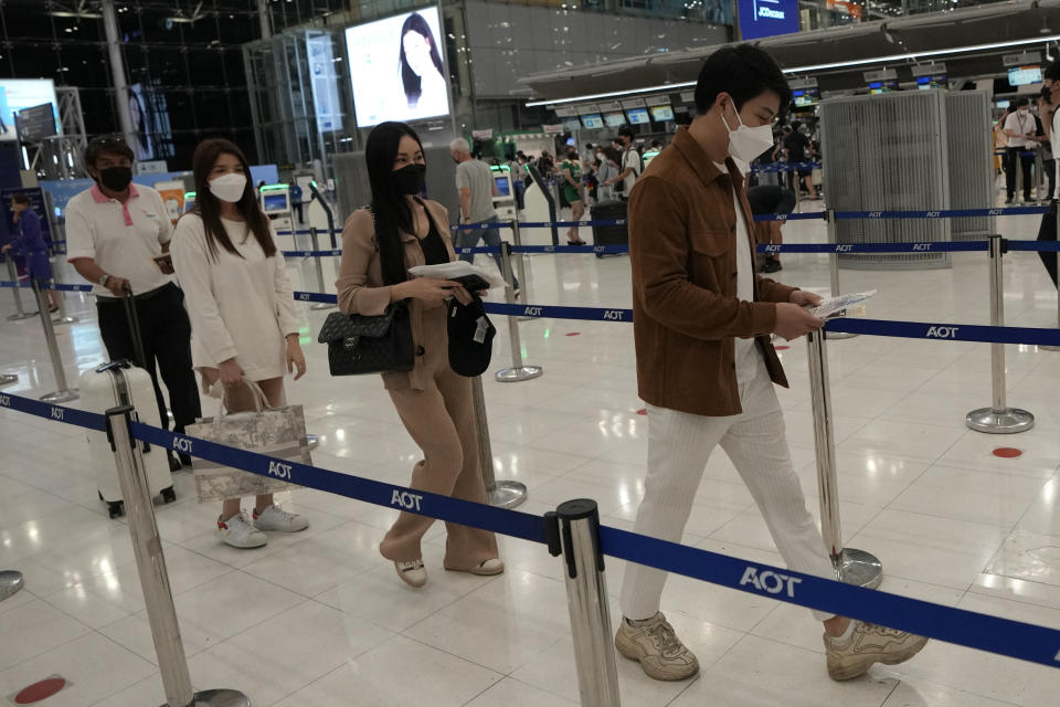 Thai travelers Tidarat Margsree second from left to right, Rossarin Chanlekha, Sathaporn Maneephol, line up for check-in for their trip to Osaka and Tokyo, at Suvarnabhumi International Airport in Samut Prakarn province, Thailand, Thursday, June 23, 2022. A group of eight young Thai travelers are excited to return to their favorite tourist destination. Japan is bracing for a return of tourists from abroad, as border controls to curb the spread of coronavirus infections are gradually loosened. Visas are being given only to certain countries, including Thailand and the U.S., that are deemed to pose a minimal health risk, so people can enter without a quarantine. (AP Photo/Sakchai Lalit)