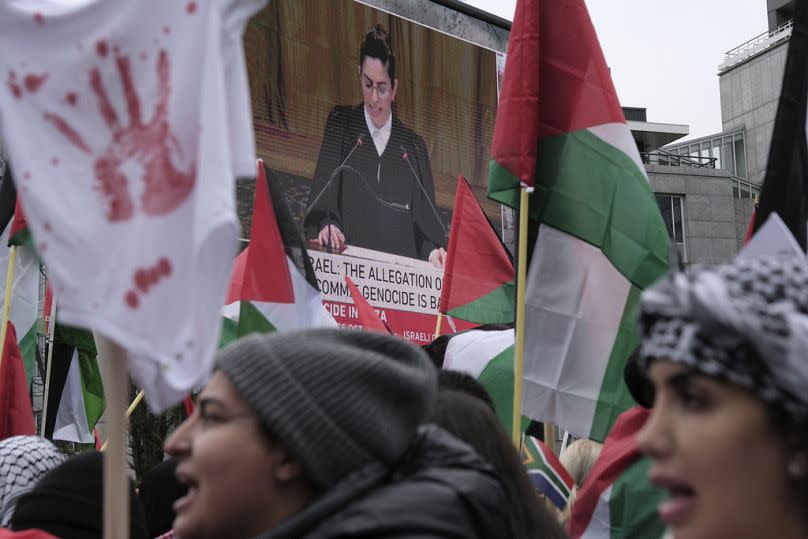 Protesters shout slogans outside the International Court of Justice in The Hague, Netherlands, Friday, Jan. 12, 2024.