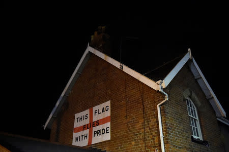 An England flag bearing the words: 'This flag flies with pride' is affixed to the side of a house in Redcar, Britain March 1, 2019. REUTERS/Clodagh Kilcoyne/Files